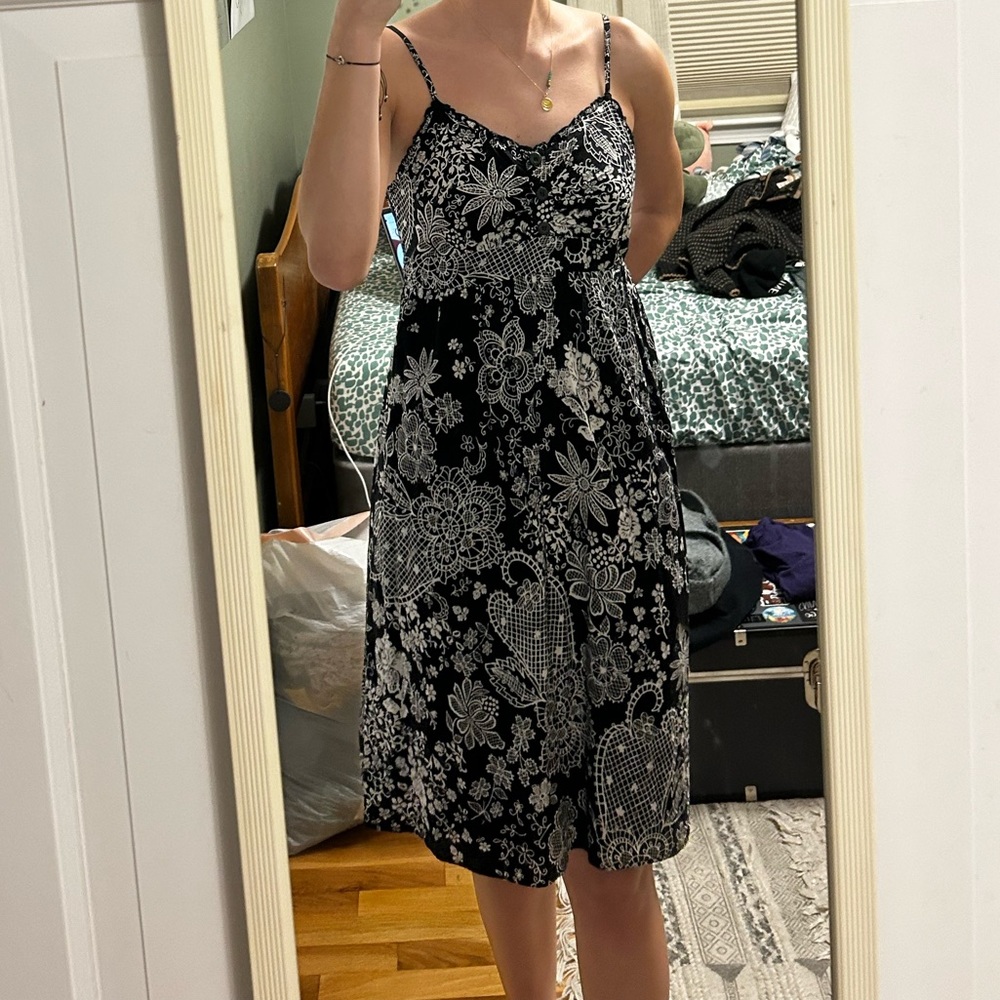 Black knee length floral dress, sweetheart neckline and button detail on front